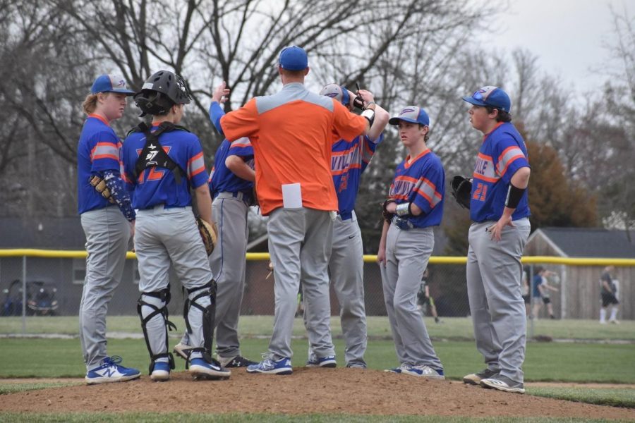 Coach+Obermeier+talks+with+the+infield+during+a+mound+visit.