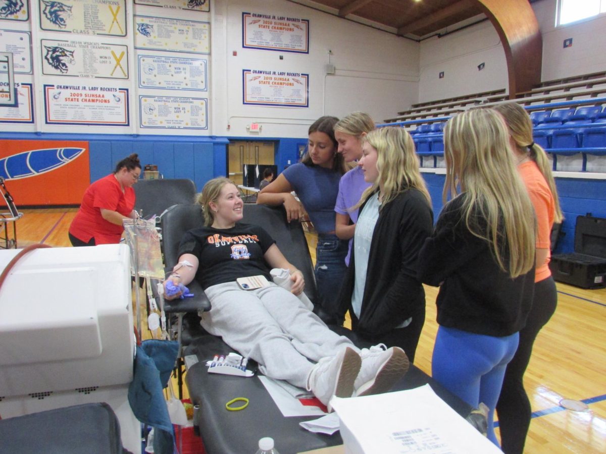 Students supporting Brynn Rhodes while she gave blood