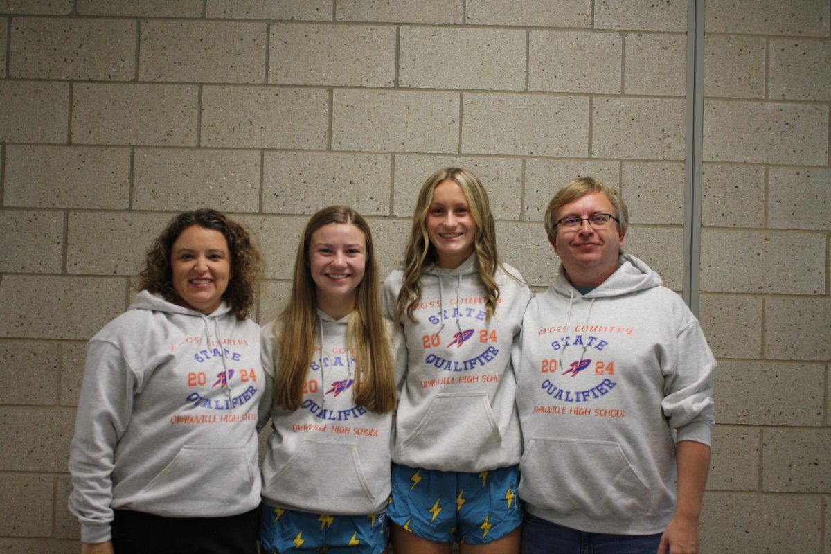 Runners, Caroline Tepe and Sidney Charles, pictured with their coaches, Val Tepe and John Laughlin, before their sendoff.