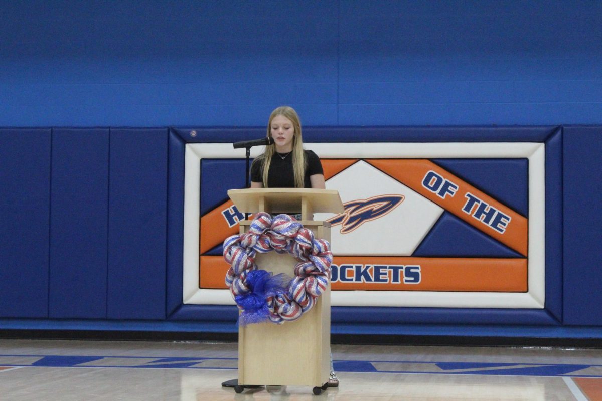 Peyton Harris reads her winning essay at the Veteran's Day Assembly.