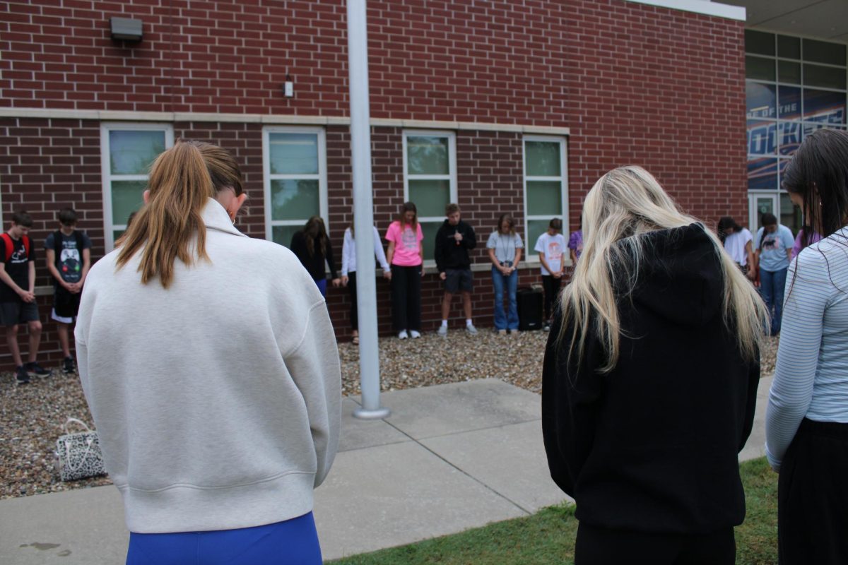 OHS students gathered around the pole.